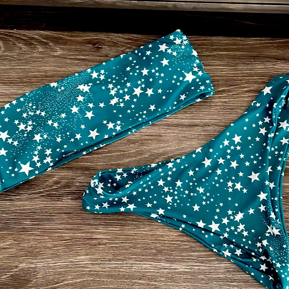 Teal with white star; two-piece swim suit. Never worn.